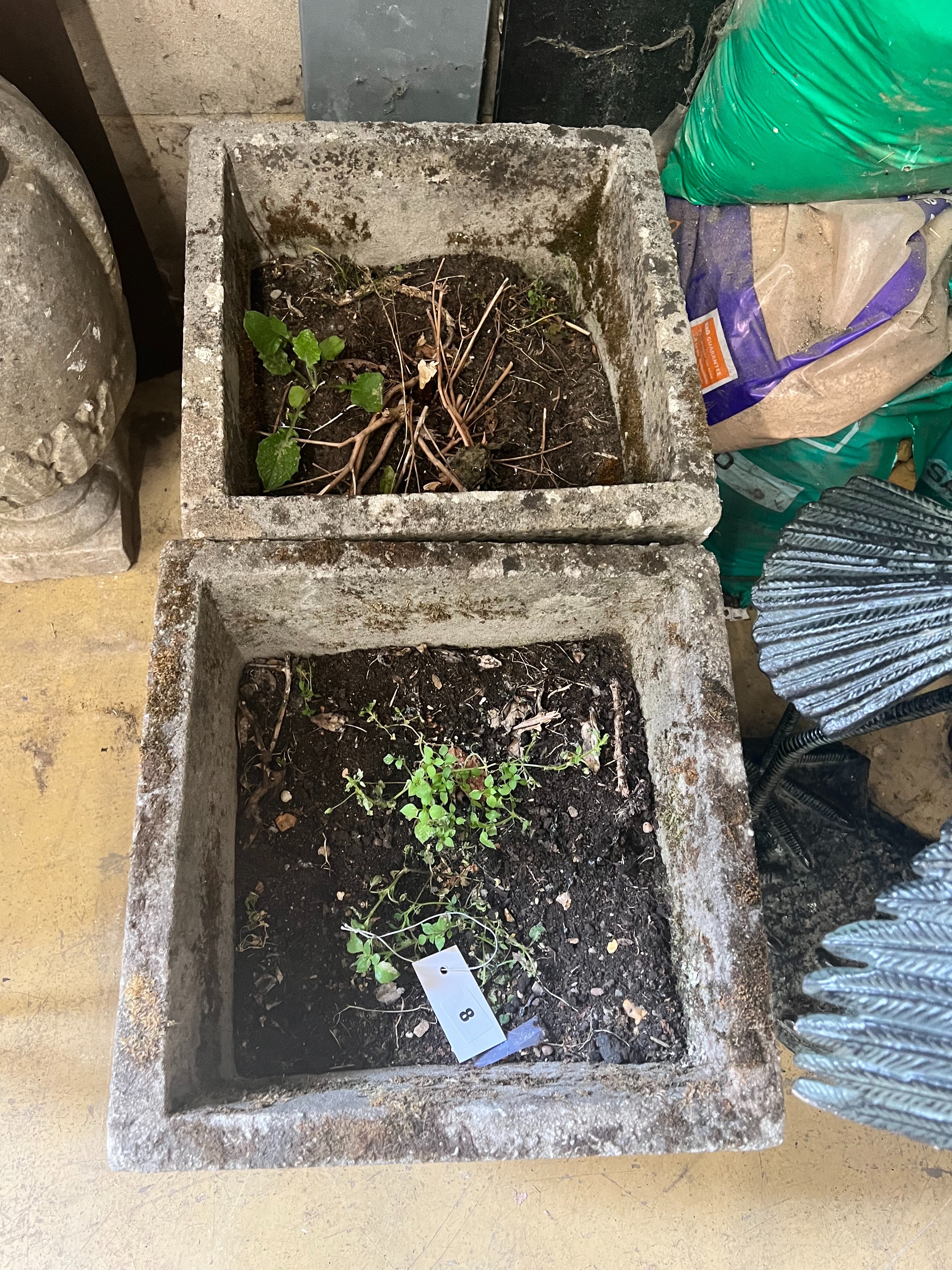 A pair of reconstituted stone square planters with rose motif, width 37cm height 36cm